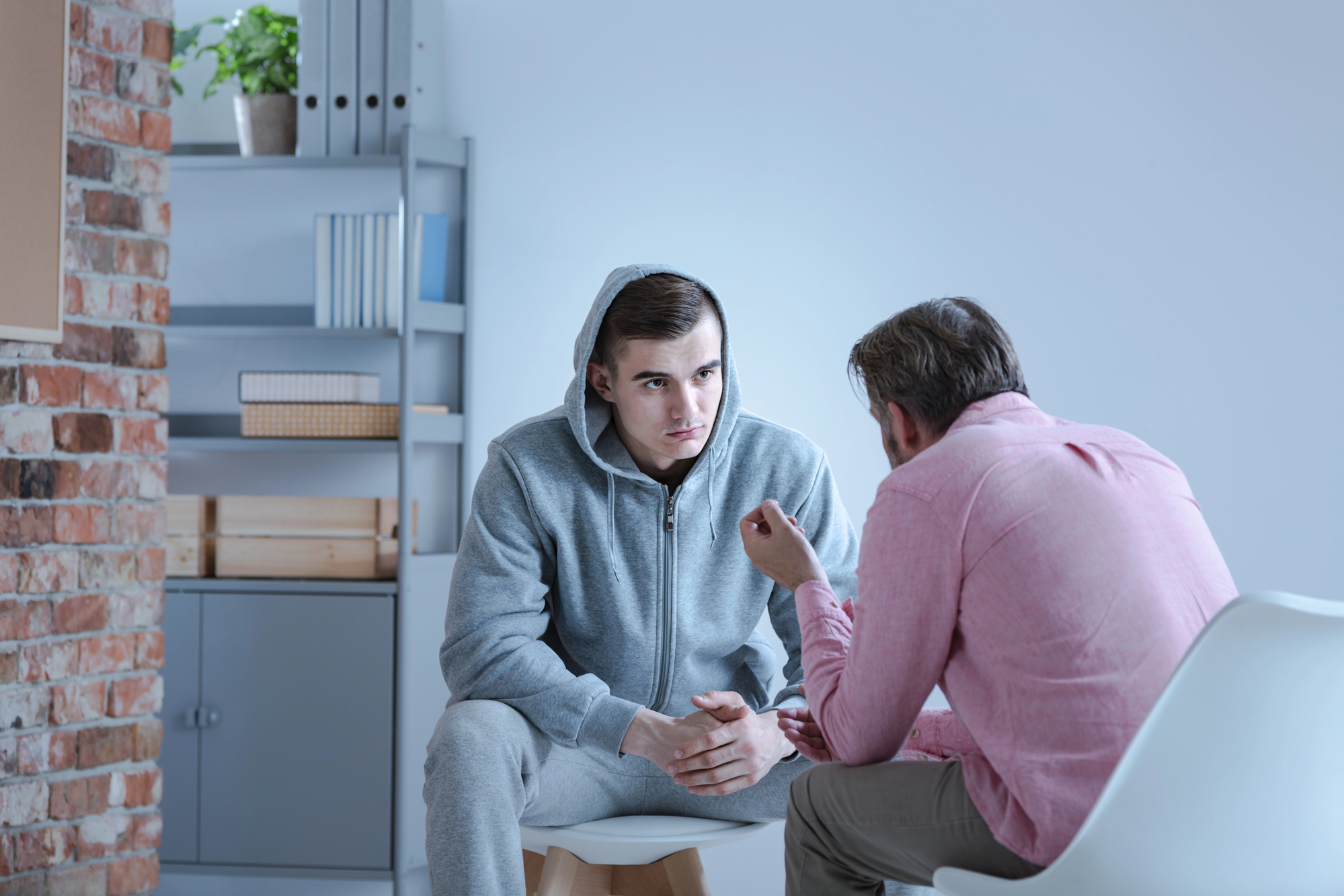 Man discusses treatment options and sober living with provider.