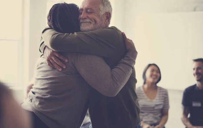 man hugging at contigency management group