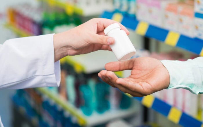 Pharmacist fills prescription for patient.