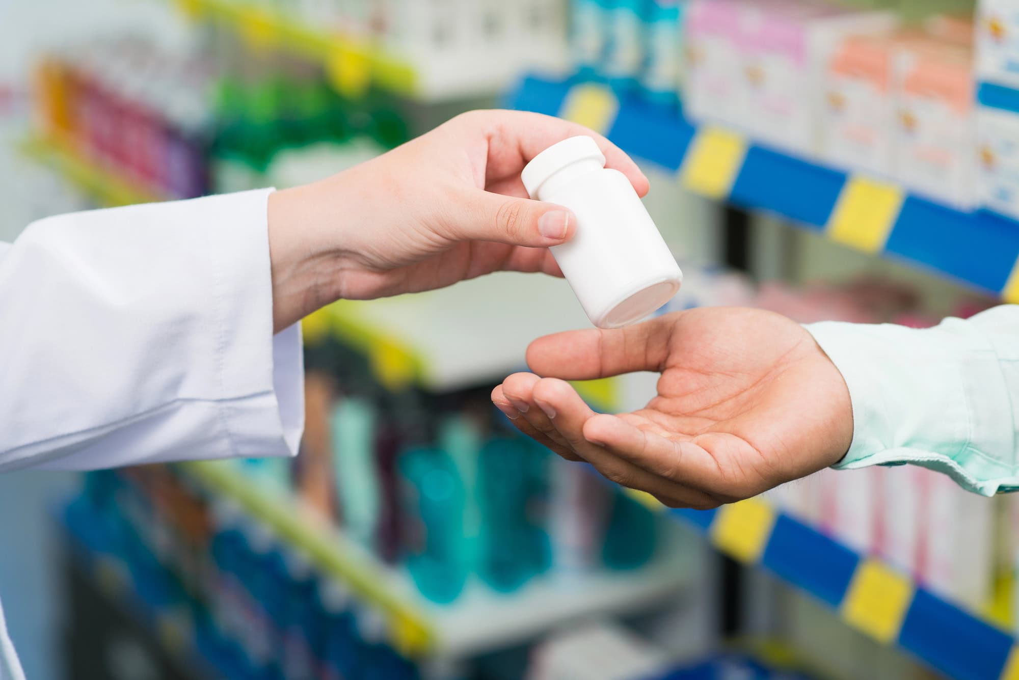 Pharmacist fills prescription for patient.